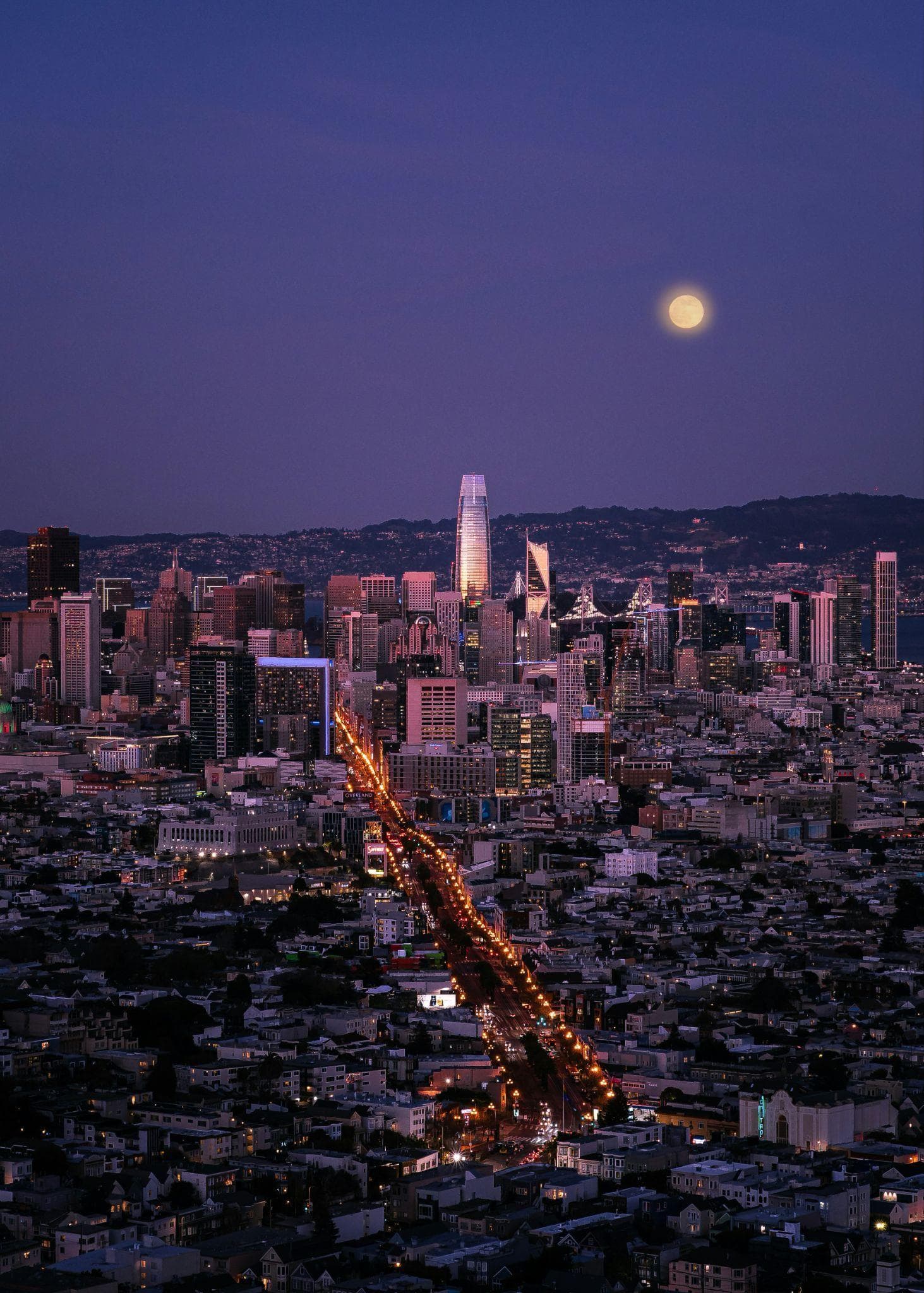 San Francisco skyline at dusk under a full harvest moon